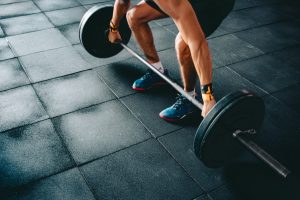 man deadlifting barbell